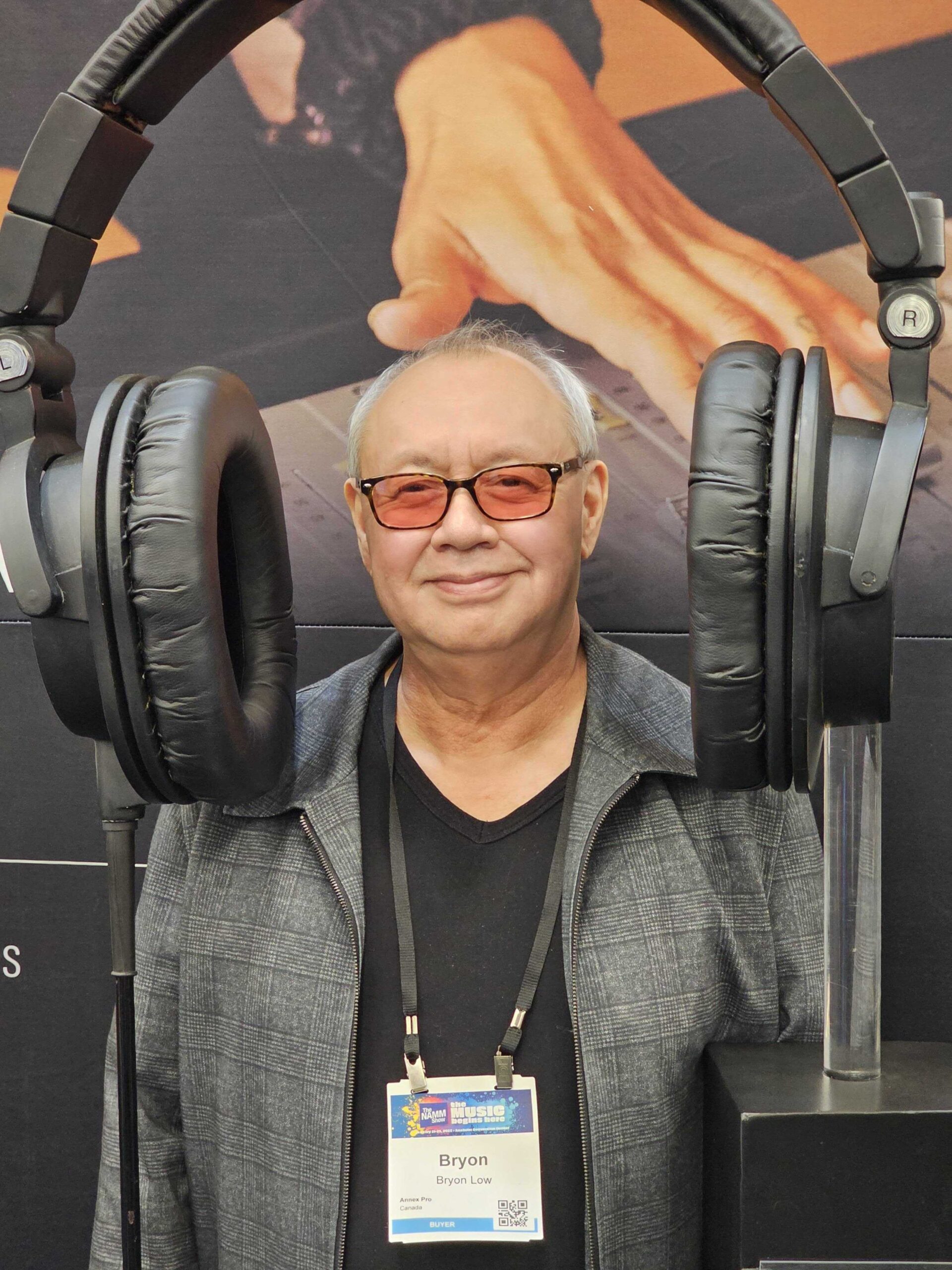 Bryon wearing the world's largest headphones at the AudioTechnica booth at NAMM